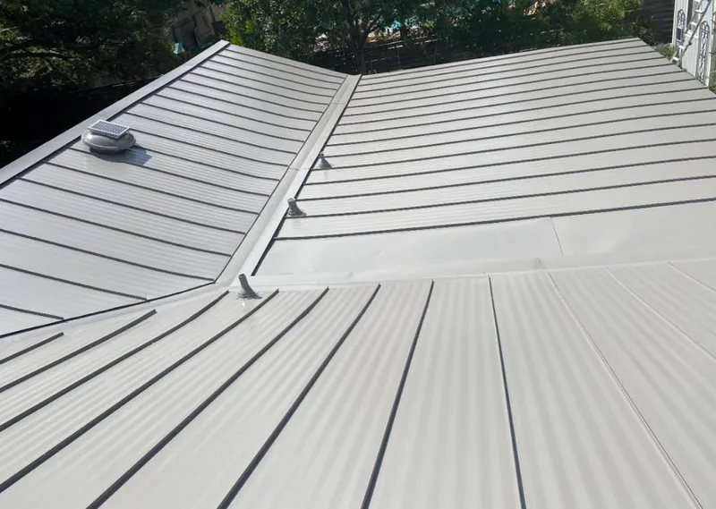 Solar attic fan installed on a metal roof for Roof Ventilation in Napoleon